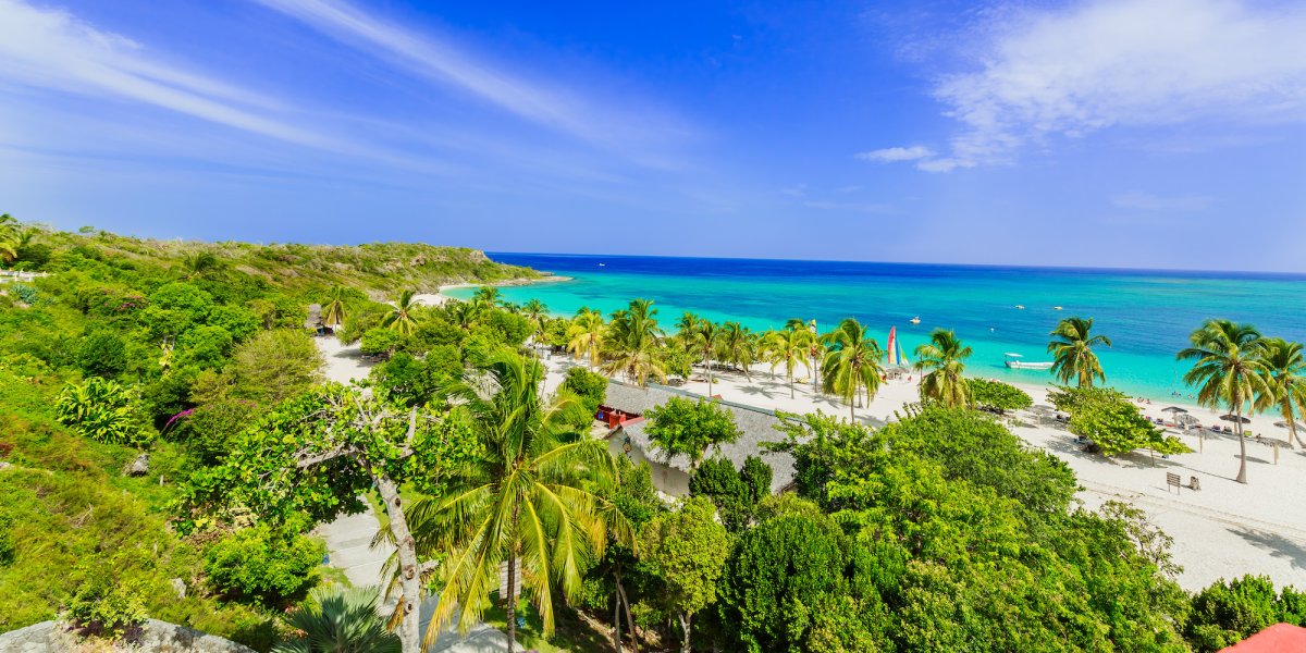 Wide open white sand beach in Holguin, Cuba on a sunny day