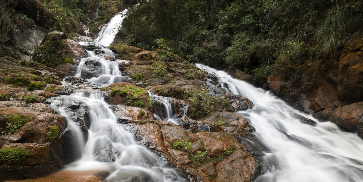 Waterfall over moss covered rocks in eastern Cuba