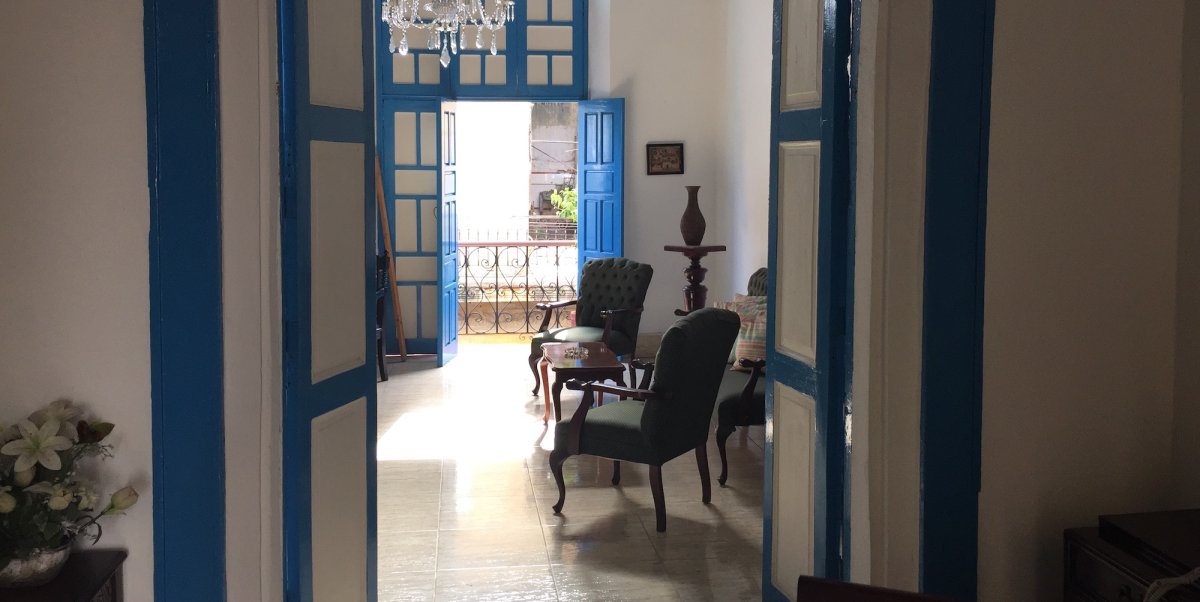 A look inside a Cuba Casa Particular through the front door that is blue and white