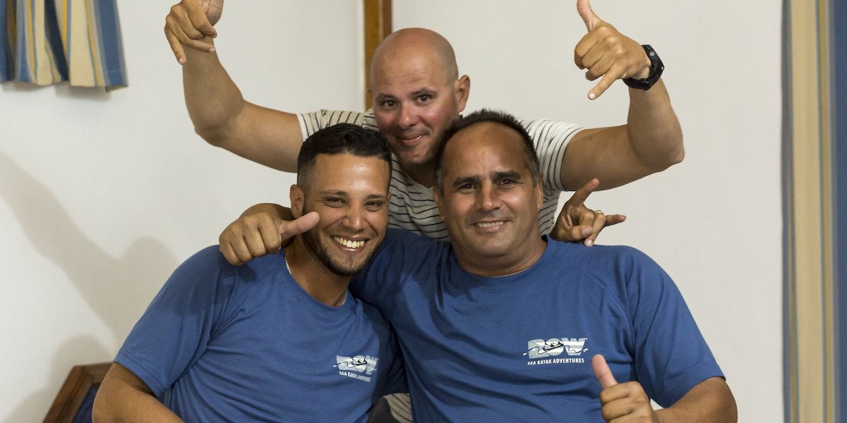A group of three cuban guides on a tour in Havana.