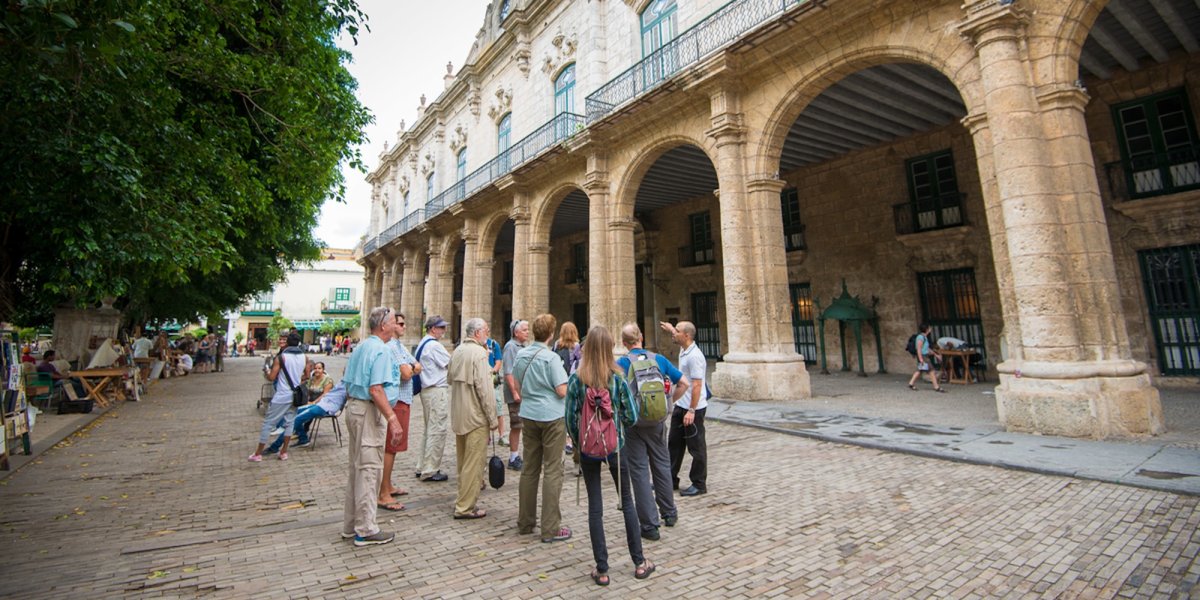 Guided walking tour through Old Havana’s historic district, a cultural highlight on immersive Cuba vacations.