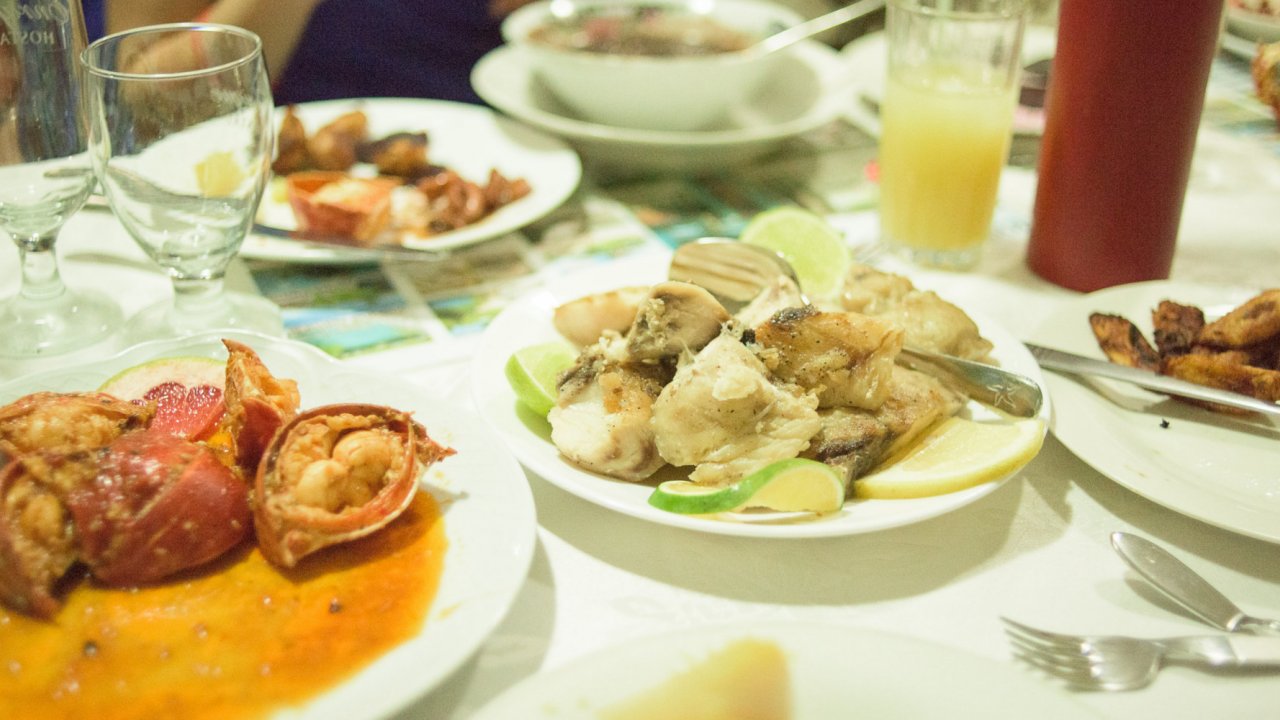A table set with many plates of Cuba cuisine.