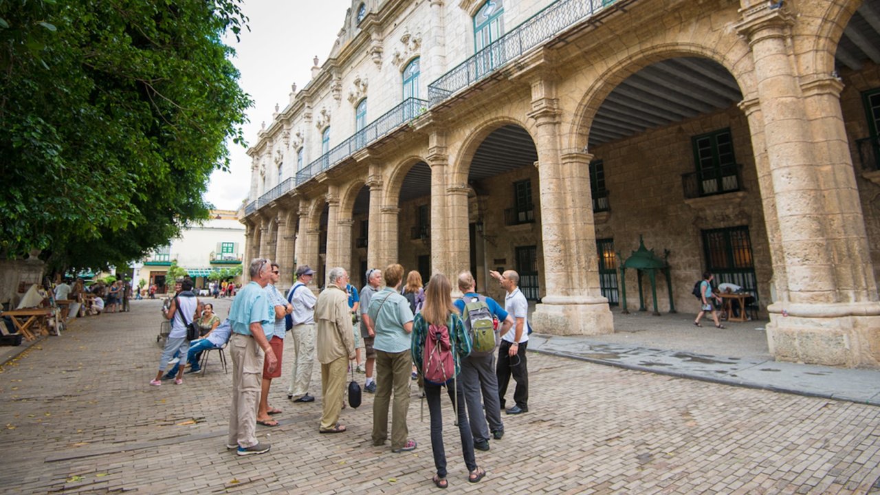 A group of tourists on a walking tour in Havana Cuba.