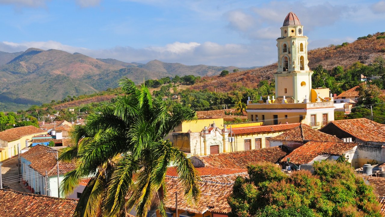 Colorful colonial buildings lining a cobblestone street in Trinidad, Cuba, a popular Havana Cuba excursion destination.