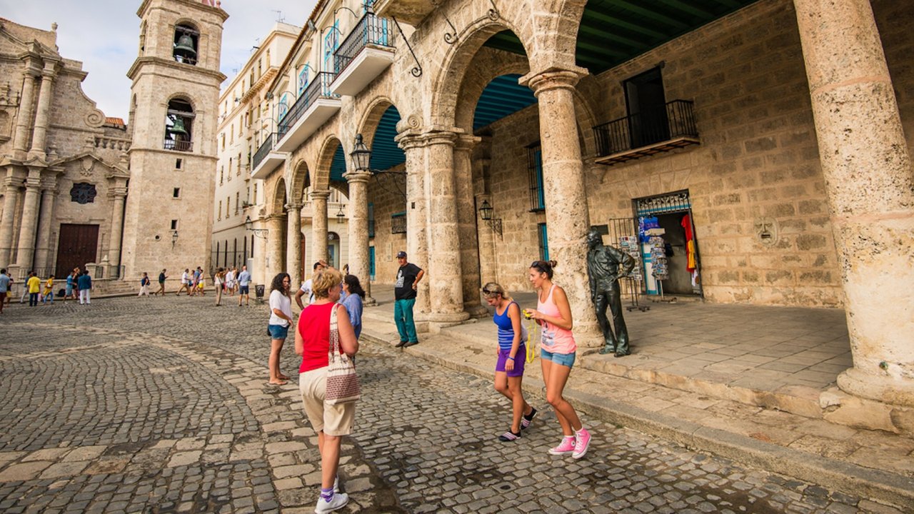 Travelers explore Plaza de la Catedral in Old Havana, Cuba, surrounded by historic architecture and lively culture during a weekend in Havana travel tour.
