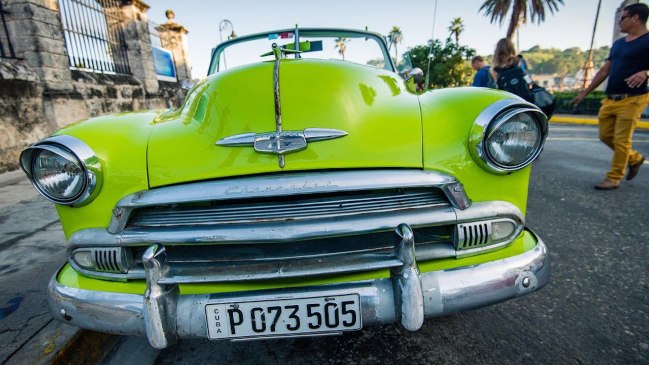 A neon green old convertible in Havana Cuba.