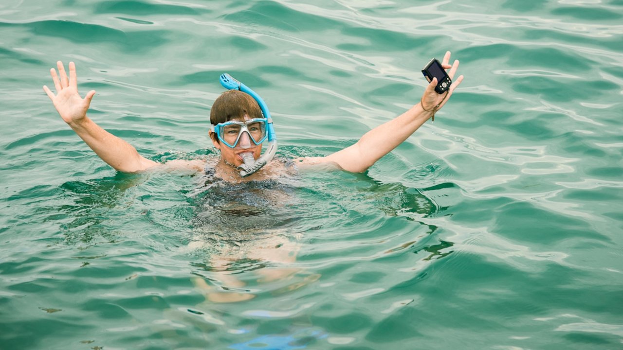 Traveler snorkeling in the clear Caribbean waters during a coastal adventure on a guided trip to Cuba from the US.