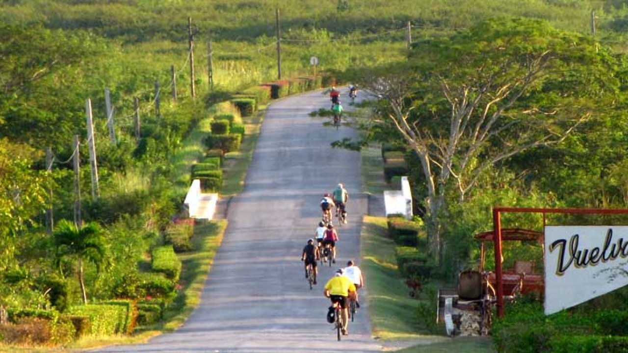 Birds eye view of a group of cyclists biking away from the camera in Cuba