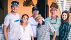 Travelers and local hosts share smiles and connection outside a Cuban guesthouse—highlighting the warmth, hospitality, and cultural exchange at the heart of this Cuba adventure.