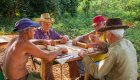 A group of people sitting around a table playing a game in Vinales Cuba