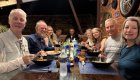 Group of travelers enjoying a shared meal after a day of cycling on a guided Cuba tour, connecting through food and culture during Cuba travel