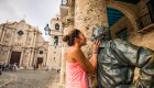 woman standing with statue in Havana Cuba