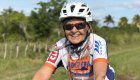 Smiling cyclist wearing a helmet during a guided Cuba bike tour through rural countryside, highlighting active Cuba travel experiences