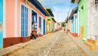 Scenic view of Trinidad, Cuba with colonial rooftops, palm trees, and mountains in the background on Cuba’s eastern coast.